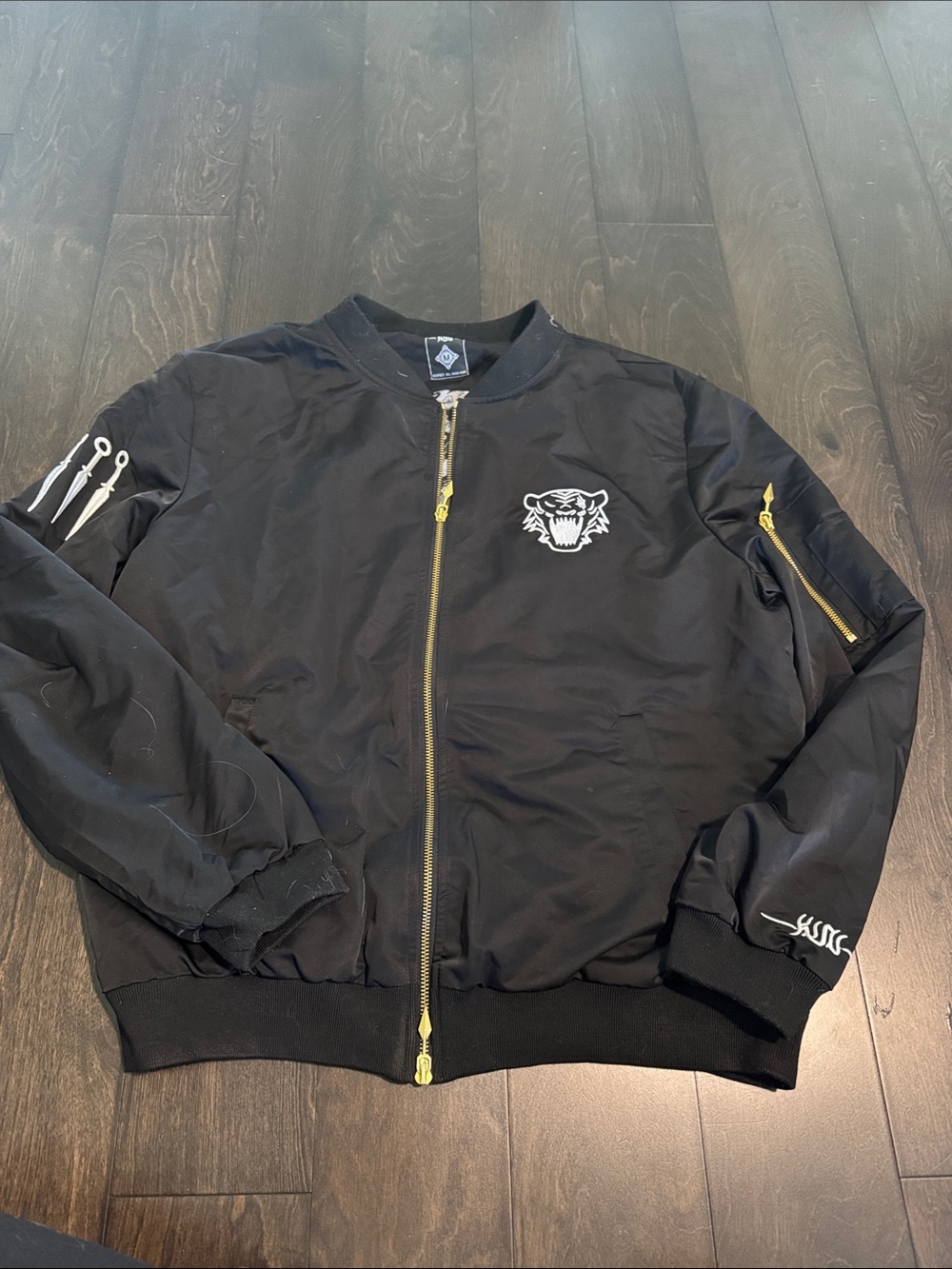Black Bomber Jacket with White Tiger Patch and Gold Zipper Accents